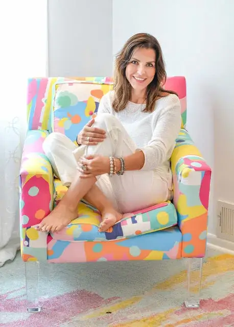Nashville real estate agent Victoria Anest seated in a designer chair